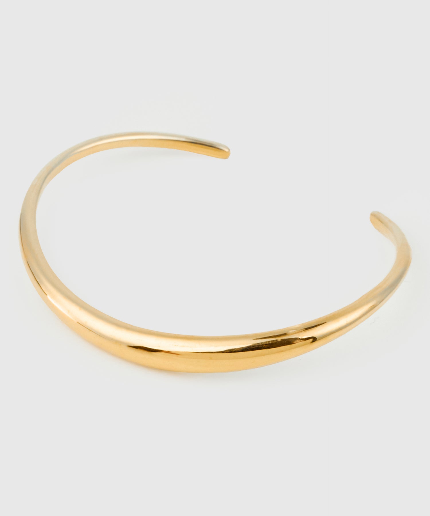 Best Japanese Jewelry Brands: 21 Labels to Know (2026) 20 ISOLATION open-ended curved bangle in gold-plated sterling silver with an organic flowing shape.